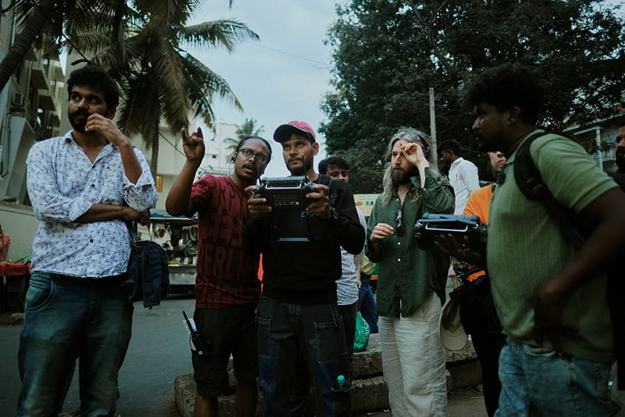 Film crew stands together and consults