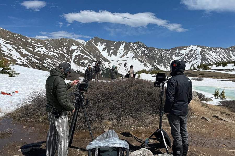 Film crew filming in a snowy landscape
