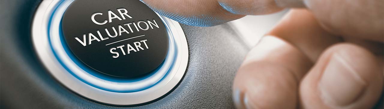Finger pressing a keyless ignition button where it is written the text car valuation start.