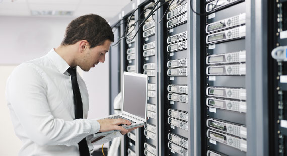 man standing in front of IT server